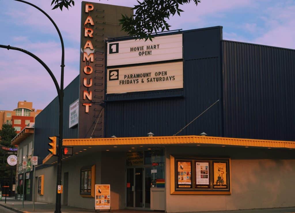 Kamloop's Paramount Theatre sits against a pink and purple painted skyline.
