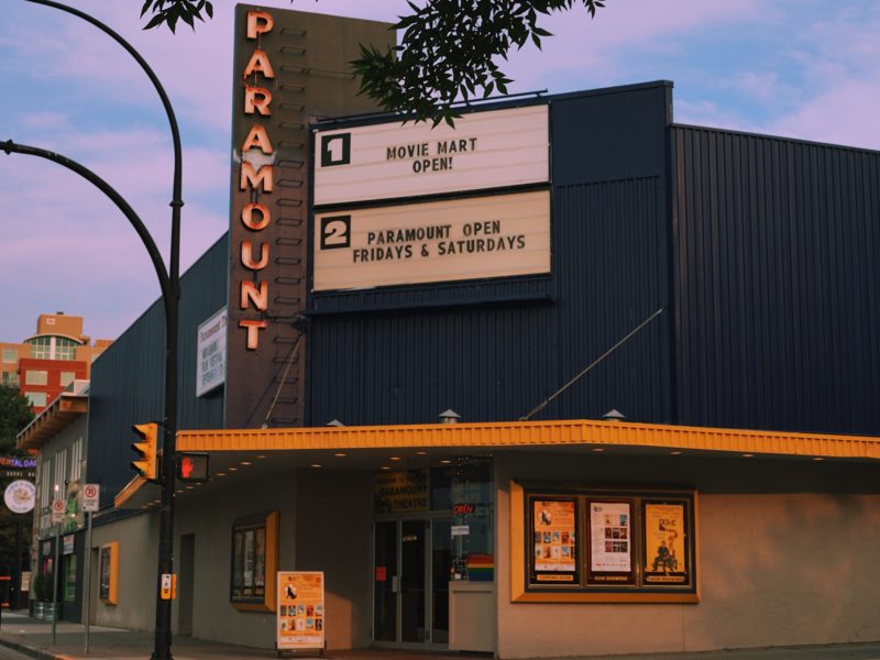 Kamloop's Paramount Theatre sits against a pink and purple painted skyline.