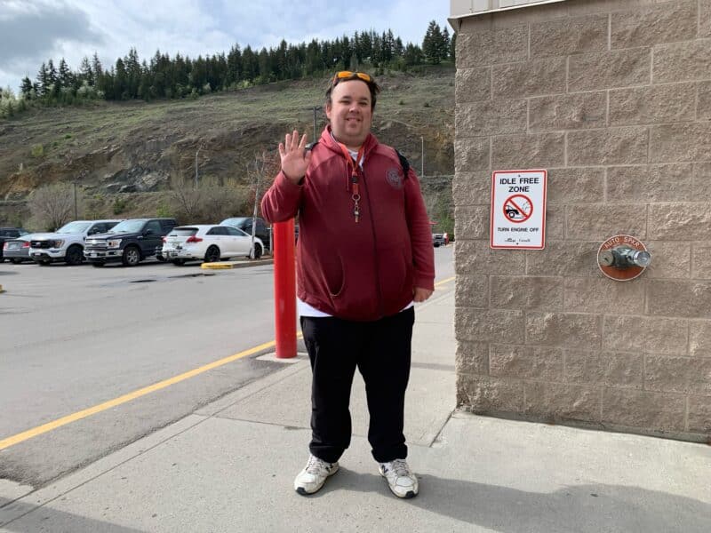 William Sheldrick waves and smiles while standing outside of Costco where he works as a "sample squad" manager. Sheldrick is a young man with a positive attitude, killer sense of humor, and autism. Sheldrick got his job through SMART options, a Kamloops-based agency that connects people with developmental disabilities—like autism, Down syndrome and Tourettes—with support and employers so they can find meaningful work.