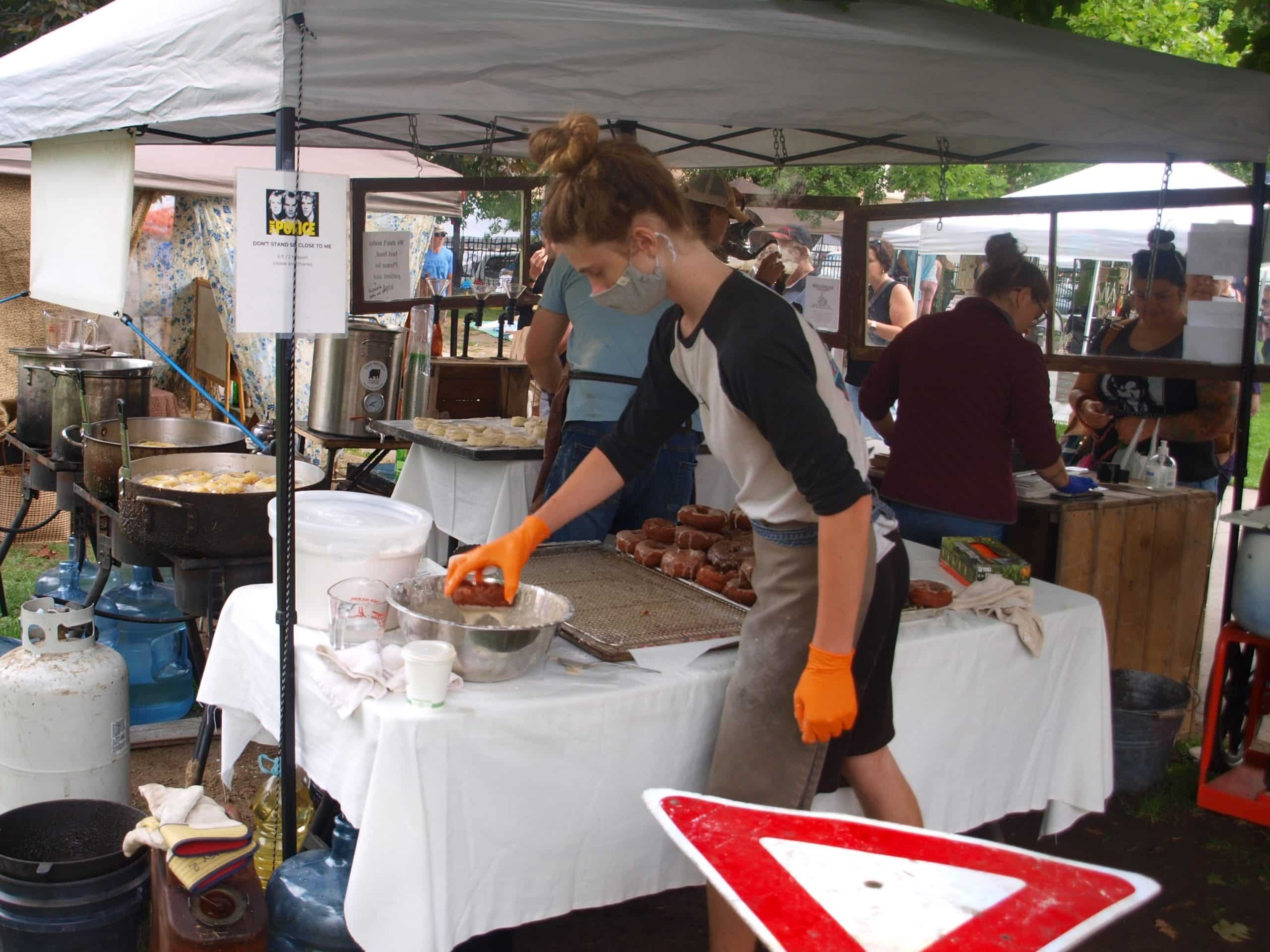 The SAROSA team busily making donuts and helping customers at the Saturday market