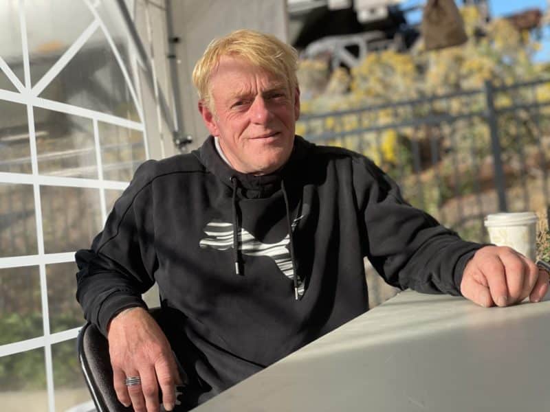 Rick Greenwood sits at a table with a coffee.