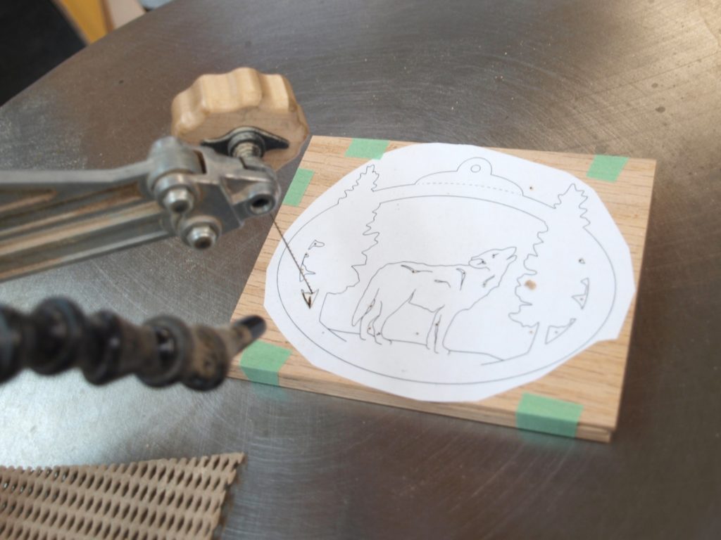 The scroll saw blade is threaded through a pre-drilled hole