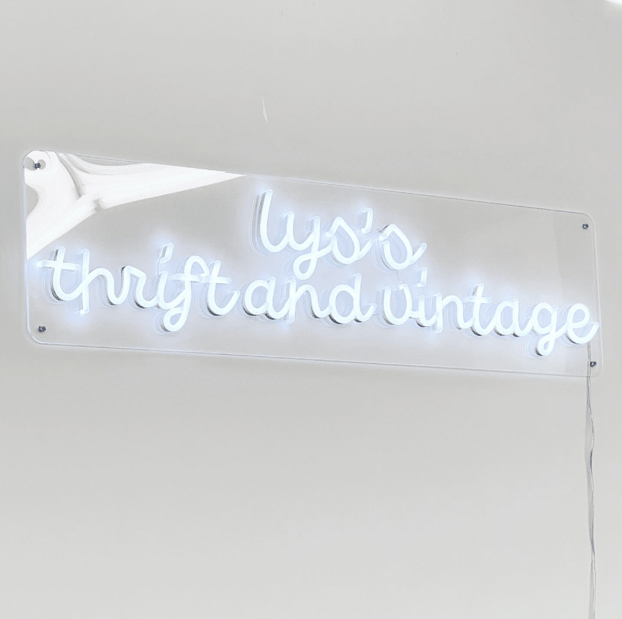 Neon sign reads 'Lys's Thrift and Vintage,' at local thrift shop in Kamloops that works to reduce waste.