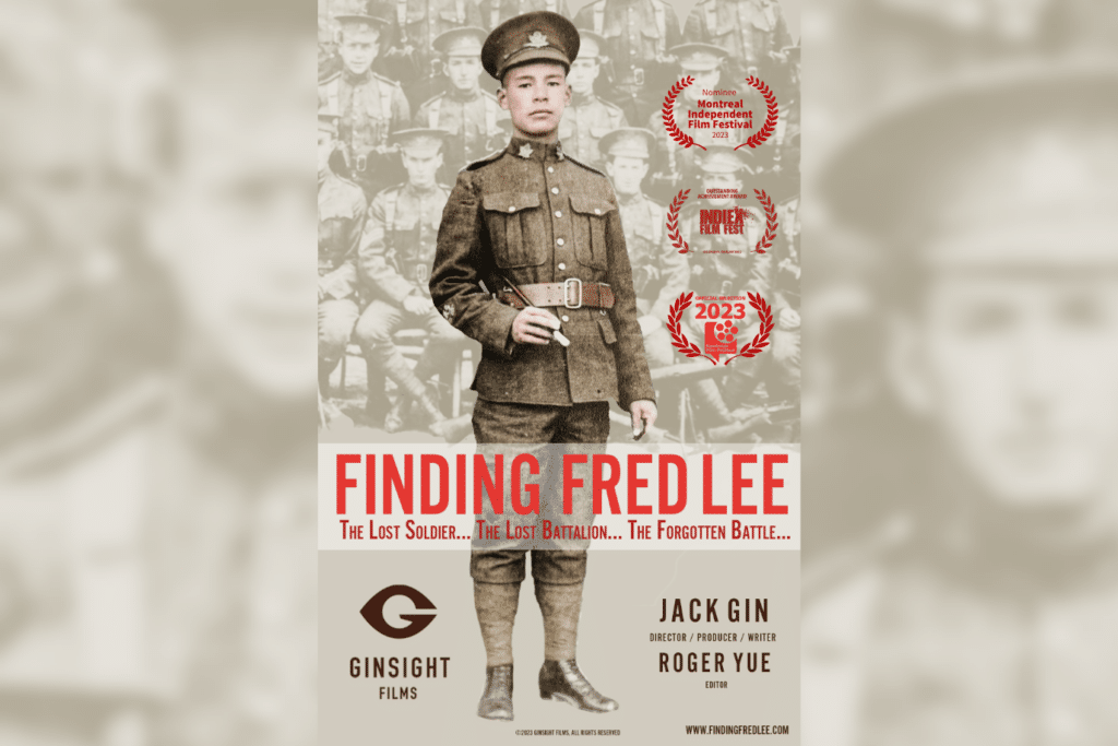 A Chinese man stands in his uniform. Poster is of 'Finding Fred Lee' documentary.