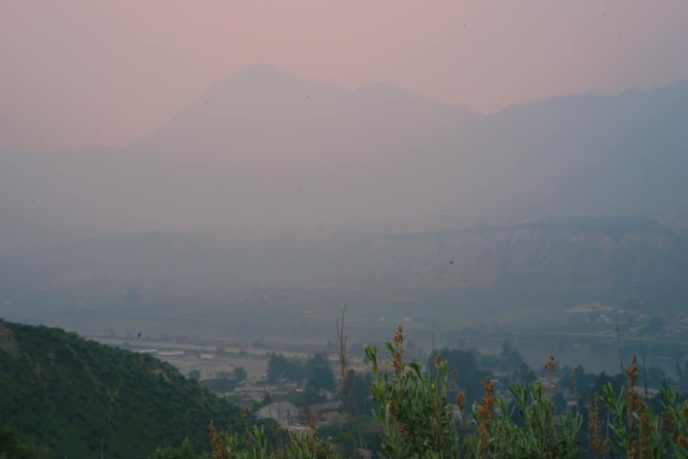 Smoky skies descend on Kamloops due to wildfires burning out of control in B.C. The image feature sage brush in front of a mountain nearly erased from view because of heavy smoke.