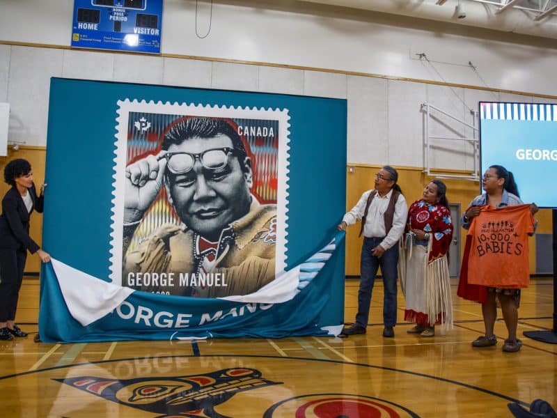Susan Margles, the chief people and safety officer for Canada Post unveils the stamp along with George Manuel Jr, Doreen Manuel and Ida Manuel. Submitted photo.