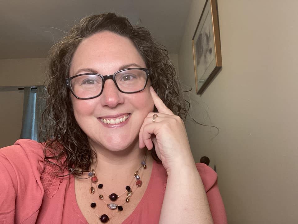 A women with curly hair smiles for a photo. She is Jolene Tinebra, an administrator for Kamloops Area Fire Watch.