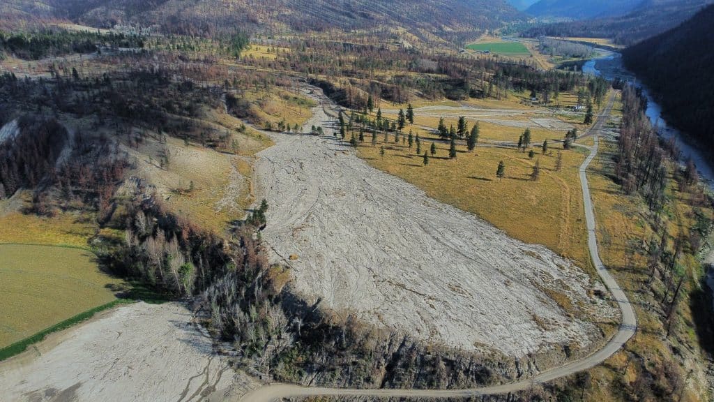 An areal view shows rivers with steep arid and charred slopes.