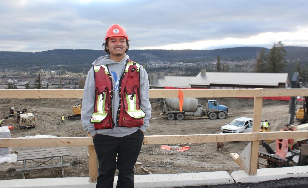 Demetrius George stands in front of a construction project. 