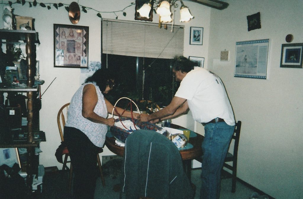 Kyé7e and Xpé7e fixing a baby basket for one of their grandchildren.