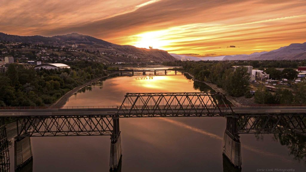 The Red Bridge is shown at sunset.