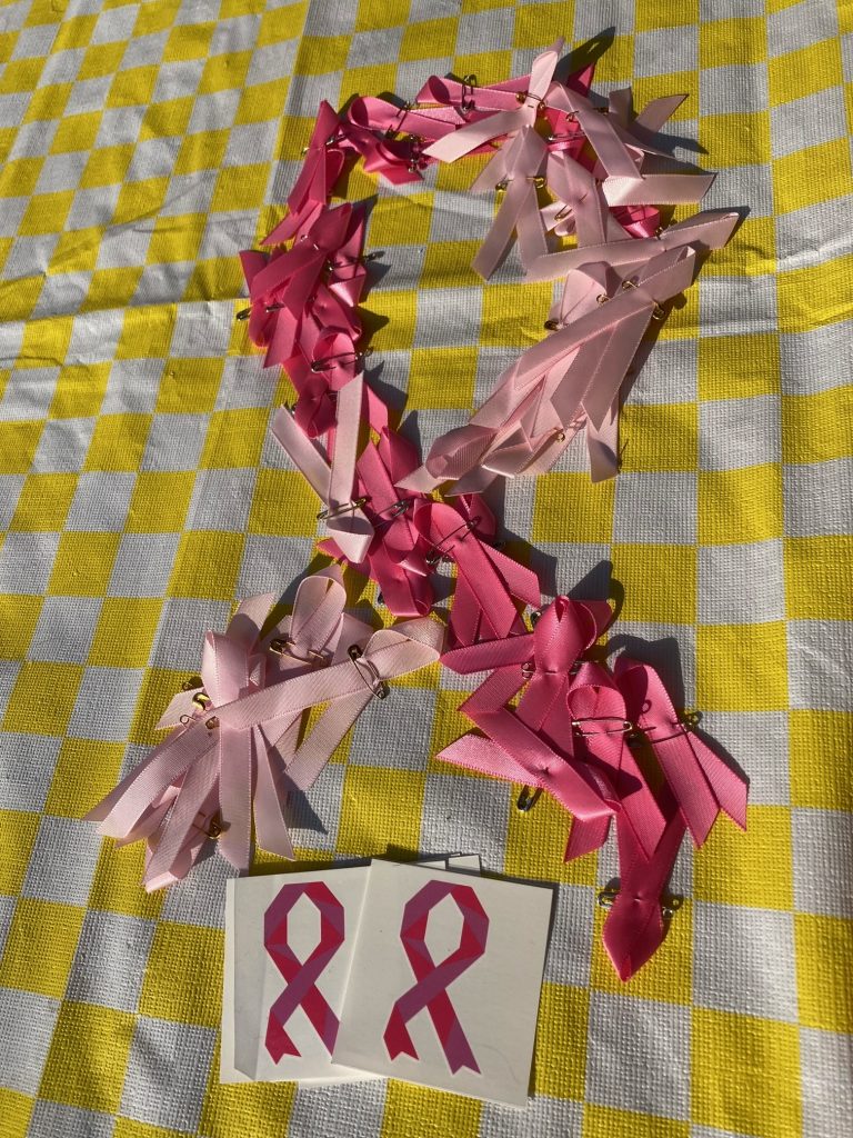 A bow in pink honoring those survivors of breast cancer.