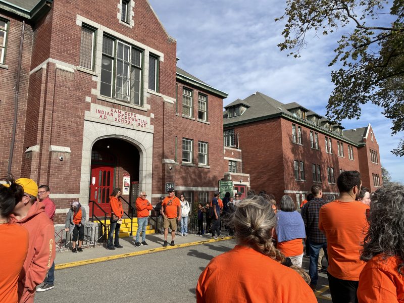 An image of the Kamloops Indian Residential School and attendees for the event of National Day of Truth and Reconciliation.