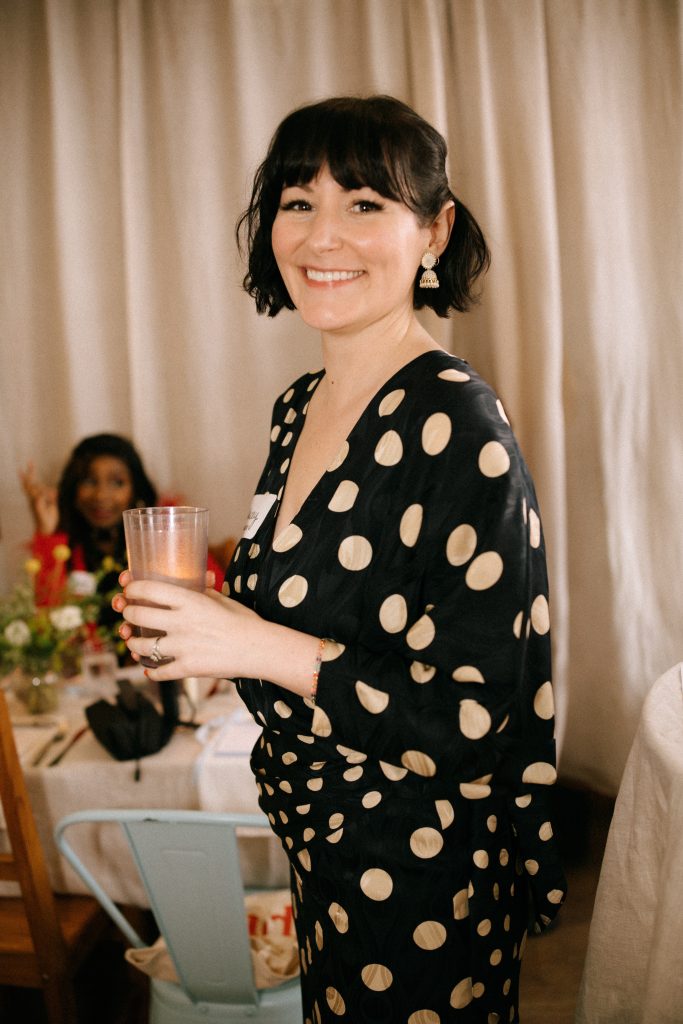 Stacey Owen at the Fullest table event wearing a black and white polka dot dress.
