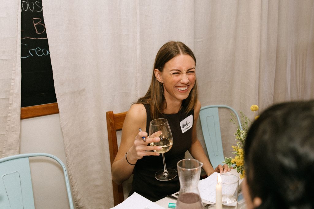 Kayla Brazier sitting down at the table while participating at the Fullest Table event.