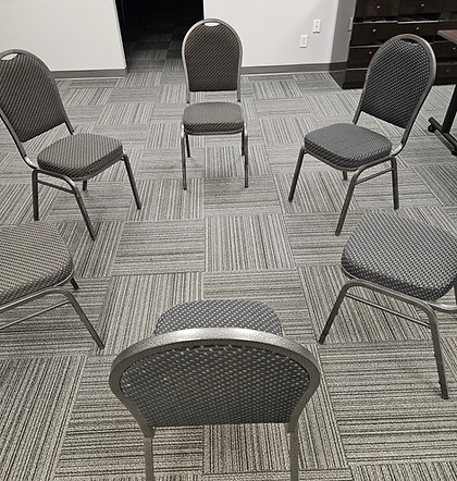 Five chairs are set in a circle which is part of Indigenous restorative justice practices. People can talk in a sharing circle about an issue.