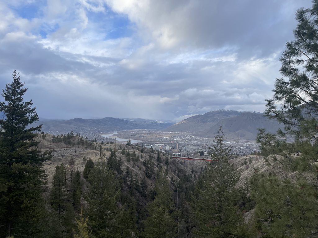 The photo shows a full view of the landscape in Kamloops. It showcases the entire city. 