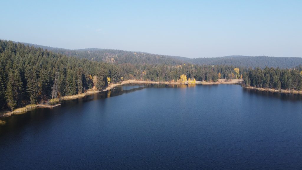 Photo of Isobel Lake with trees surrounding the area. Camping sites near Kamloops